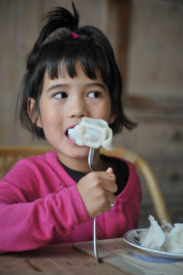 Asian Baby Eating Dumplings by Stocksy Contributor ChaoShu Li